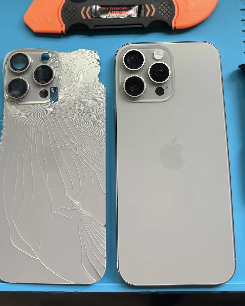 Cracked iPhone back panel next to a new replacement panel after a back-glass repair by Mobile Fix VA