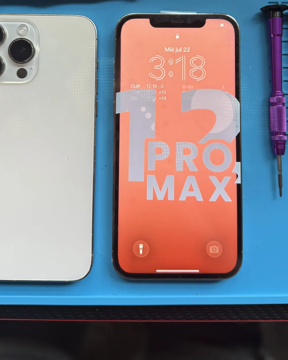 Repaired iPhone shown next to its back panel after an on-site screen replacement by Mobile Fix VA