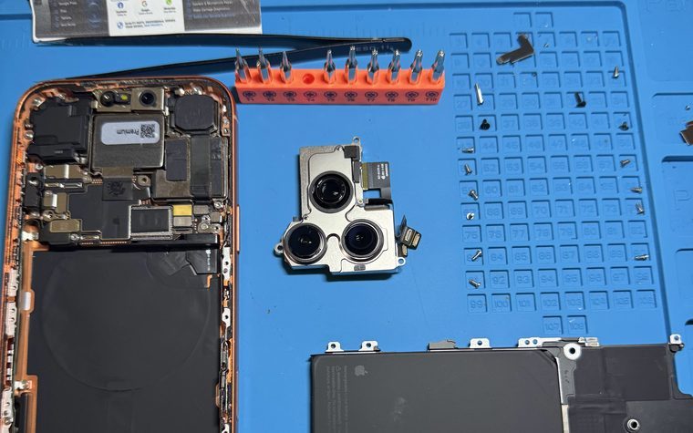 Disassembled iPhone with its camera module and shields removed during a diagnostic